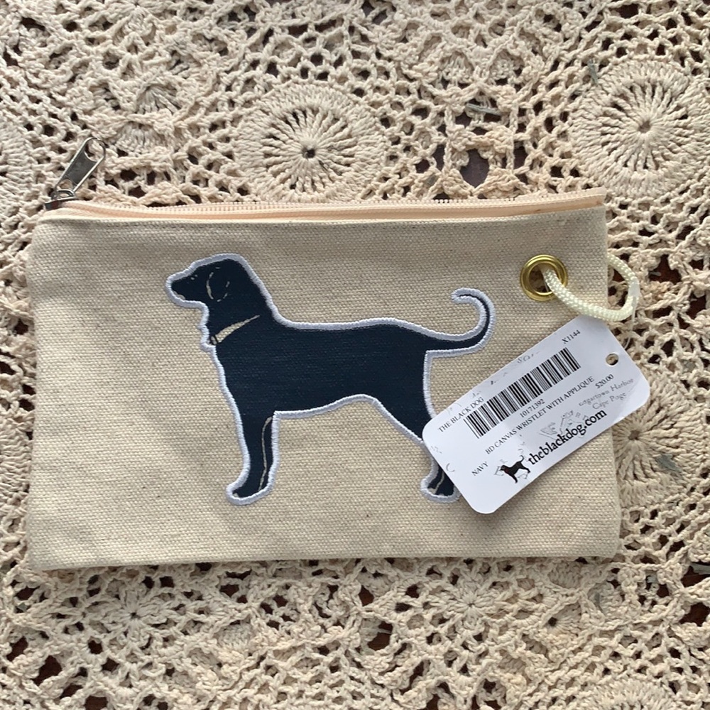 A tan black dog wallet which hasn’t been used with the tags still on it.